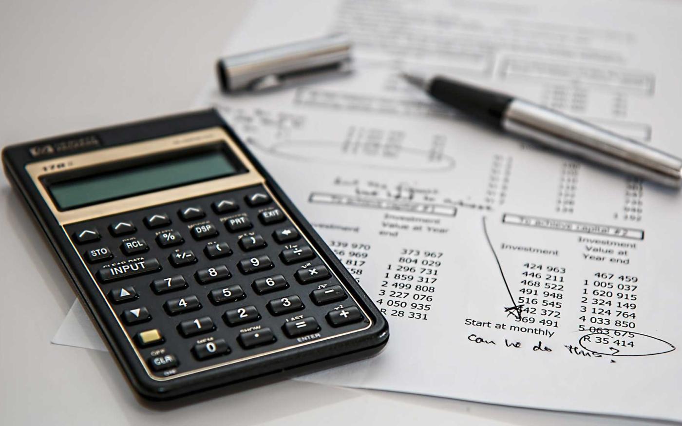 Calculator and worksheets on desk